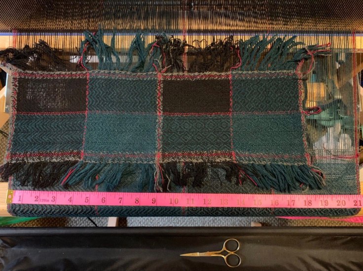 Finished sample placed on top of original warp still on loom