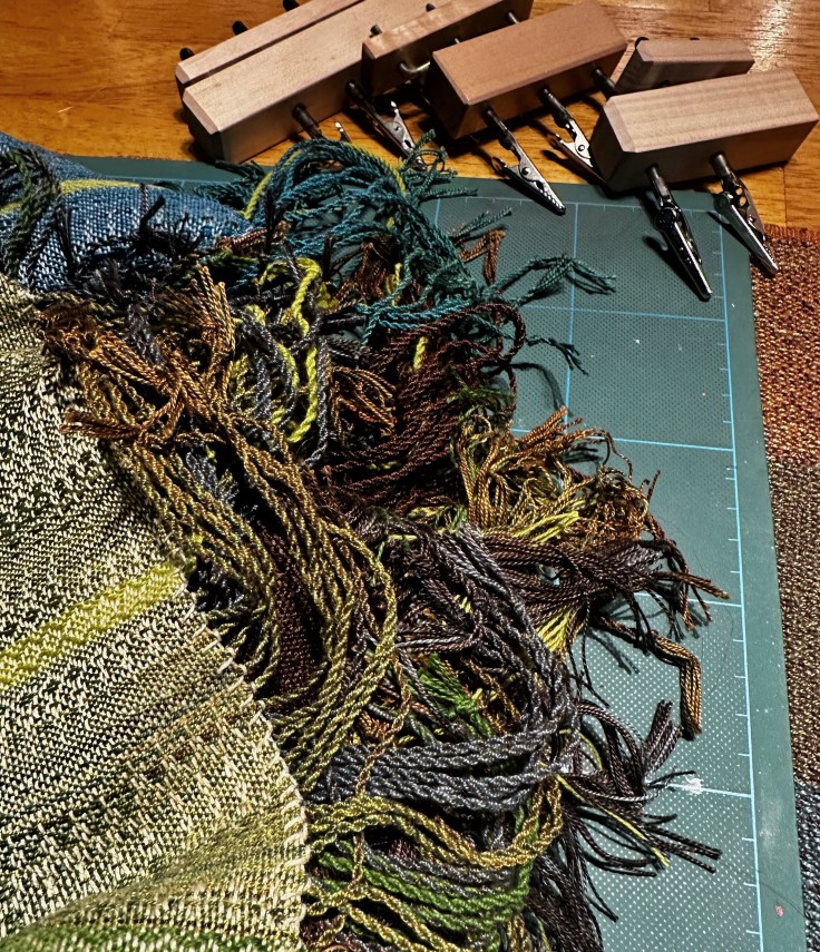 Knotted ends of scarves waiting to be twisted.