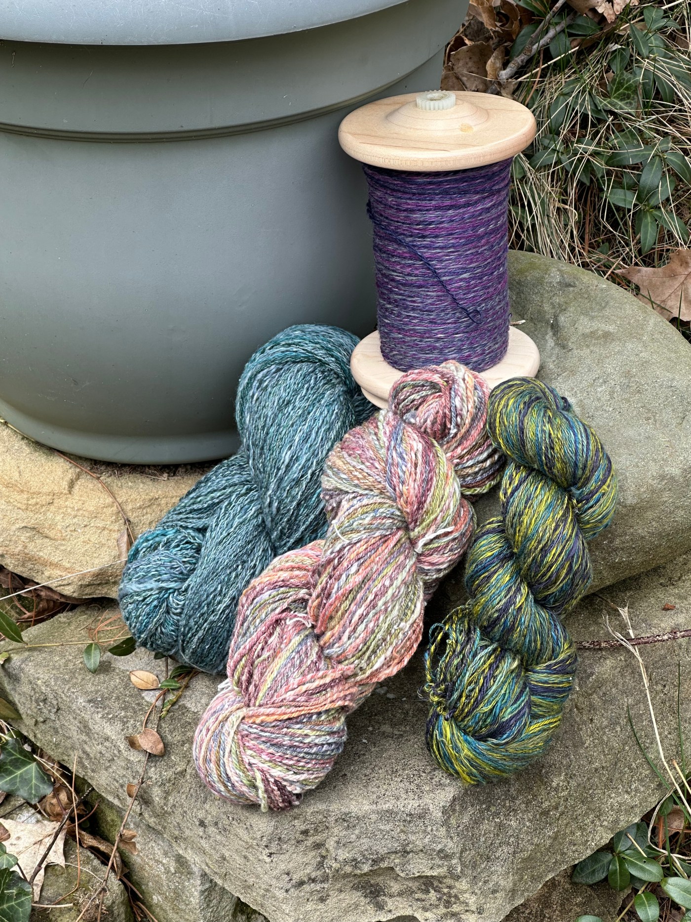 Skeins of yarn on display in a garden